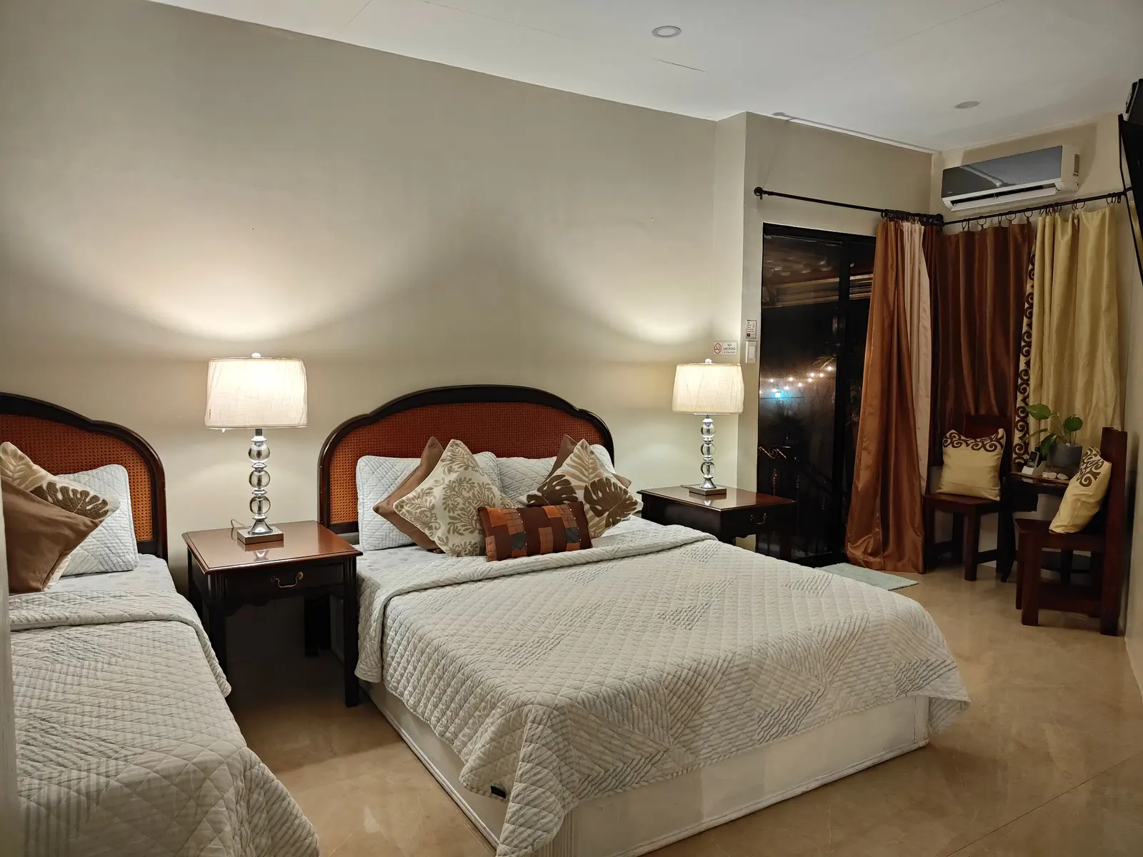 Two double beds in a cream bedroom