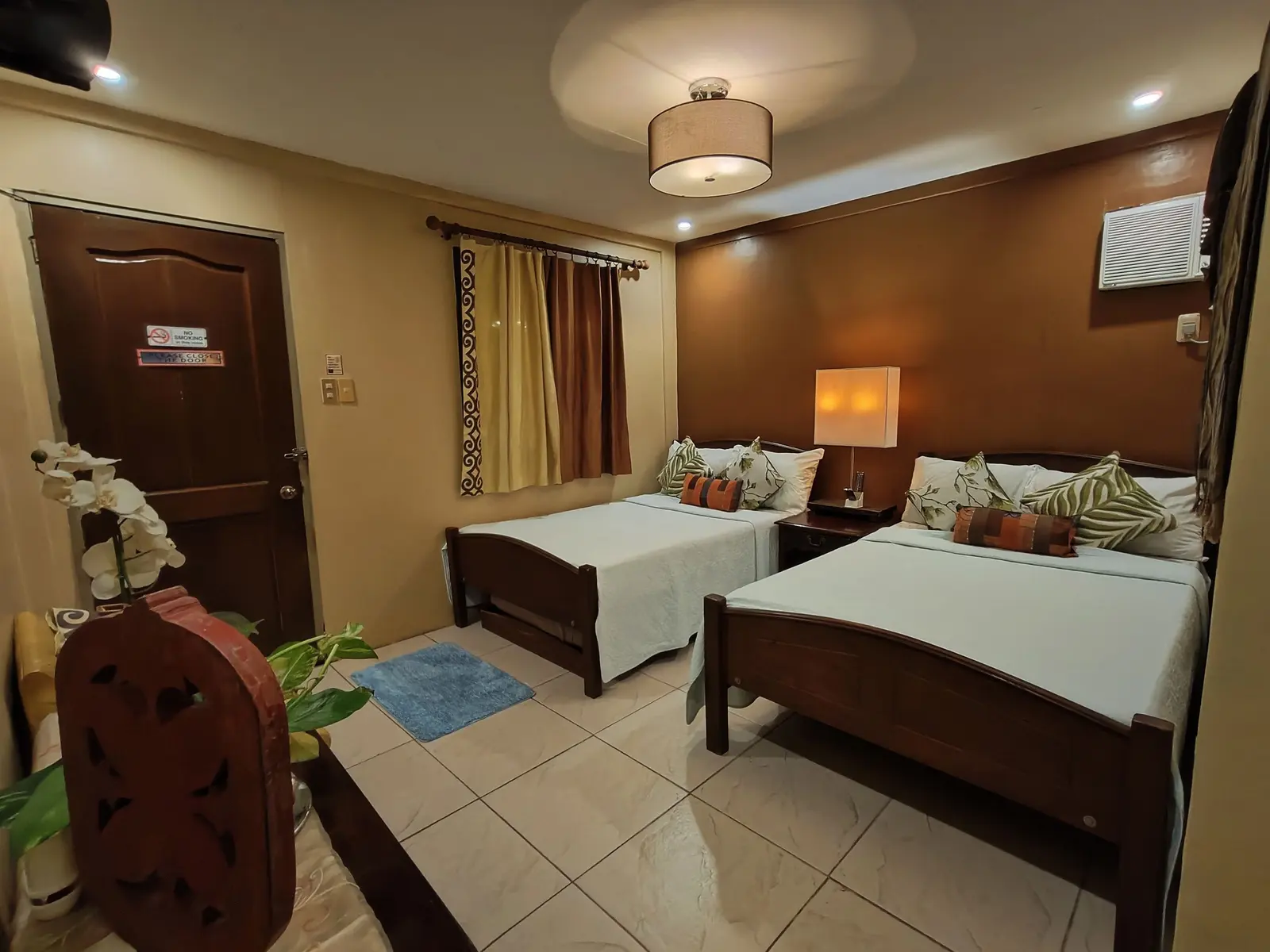 A bedroom with two beds and wooden furniture