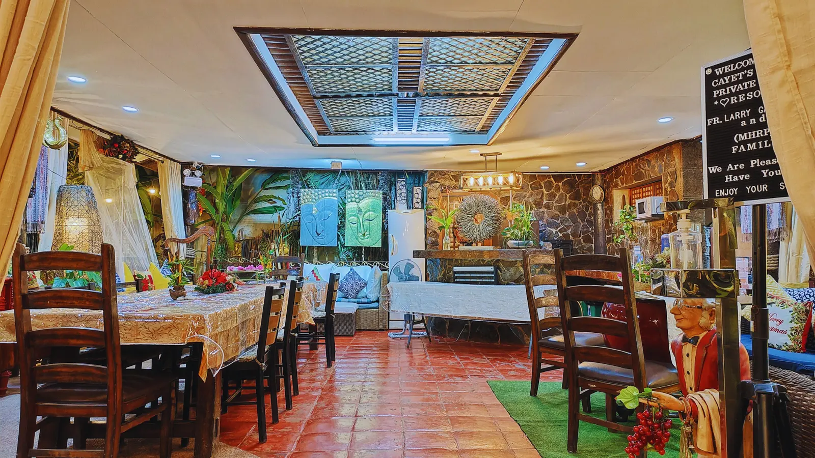The dining pavilion with long wooden tables and the garden beyond