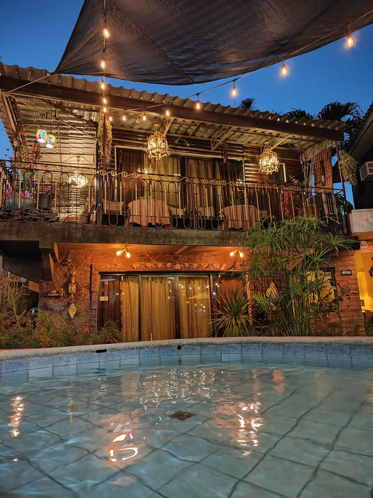 The cabin balconies glowing over the pool